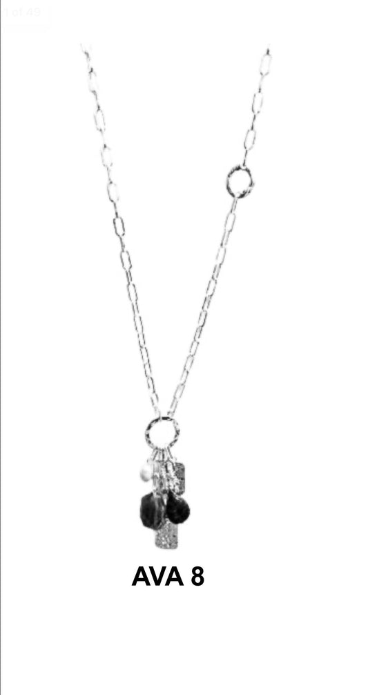 Ava 8 Silver Necklace by Elise Accessories features small dangling textured and smooth charms, displayed on a white background. "AVA 8" appears below this elegant piece from Elise accessories.