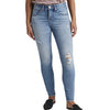 A person is wearing the Cecilia Mid Rise Skinny Jeans by JAG, which are light blue, high-waisted skinny jeans made with power stretch denim and featuring distressed details around the knees and thighs. These jeans have a button and zip closure, belt loops, and pockets. The person is also wearing black, closed-toe shoes and a tucked-in shirt.