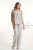 A woman wears the LinenLuv French Linen Top Print TP1131P-11 Beige with loose, light-colored linen pants and sandals. The background is plain white, featuring "LINEN LUV GERMANY" text on the right.