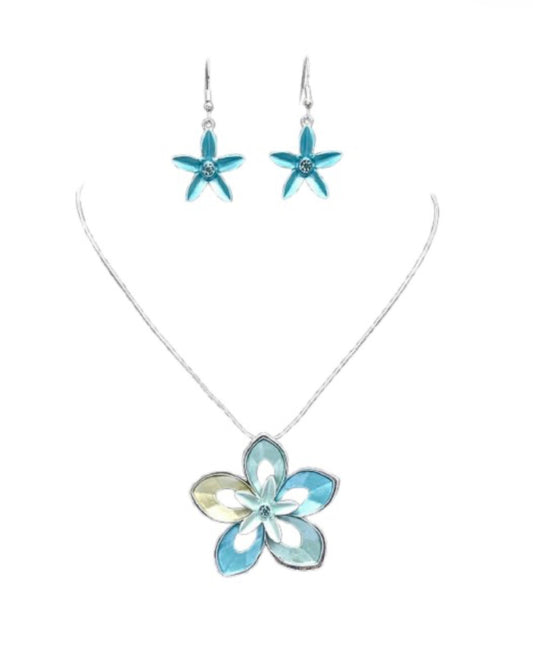 The Nicole 42 TUQ Necklace & Earring Set by Elise Accessories features a silver necklace with a blue and yellow floral pendant and matching earrings, each adorned with central gems.