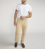 A man in a white t-shirt and Silver Jeans Co.'s Pull-On Cargo Essential Twill Pant with an adjustable waistband stands against a plain background. He's sporting black sneakers, showcases a tattoo on his left arm, and casually tucks his right hand into his pocket.