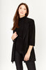 A woman with long brown hair models the Frank Lyman Long Open-Front Jacket in black (Style 236005) as a chic layering piece over a black turtleneck top and black pants, standing against a plain light background.