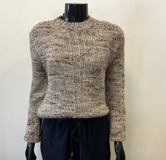 A mannequin features the fashion-forward Parkhurst VENICE CREW SWEATER 75262, a chunky knit in beige and brown with long sleeves and a round neck, elegantly paired with black pants. The minimalist white background highlights the outfit's stylish simplicity.