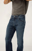 A person models the Silver Jeans Co. Konrad Slim Fit Slim Leg - M12225EFS303 jeans and a dark gray t-shirt, standing against a plain light background with their head and lower legs out of frame.