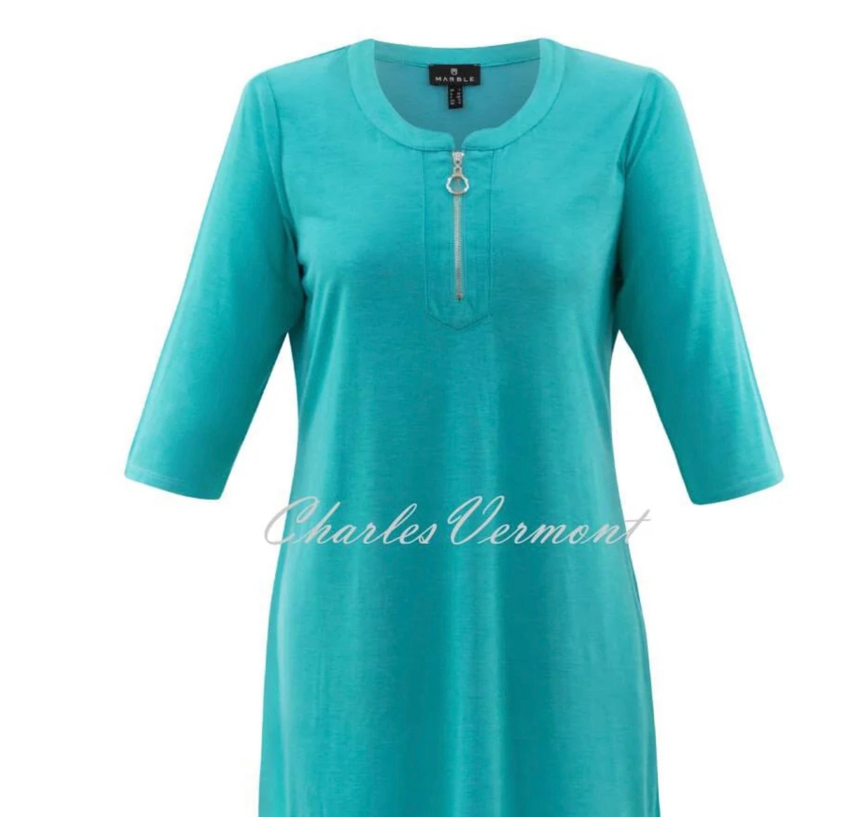 Displayed is a stylish turquoise, knee-length, A-line dress with three-quarter sleeves and a round neckline featuring a front zipper detail. The lightweight fabric looks comfortable. The brand name "MARBLE" is overlaid on the image.