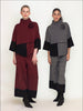 Two women model stylish outfits from the Canadian fashion brand CHAKEN's Sophisticated Duo collection. The left woman wears a maroon and black ensemble with wide-leg pants and a top featuring a flower detail, while the right woman dons a similar outfit in gray and black with matching wide-leg pants and a flower-adorned top, showcasing sustainable fashion at its best.