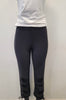 A person models Bali Corp’s Black Leggings 6279-Bali Corp, featuring decorative button and tie details near the ankles, paired with a white t-shirt, against a plain light-colored wall. Made in Canada.