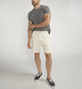 A person wearing a gray T-shirt, Silver Jeans Co.'s Painter Short M53152CTL640 in classic fit, and black sneakers with white soles stands against a plain gray background with their right hand on their left arm.