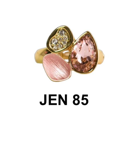 The Jenna 85 Pink CZ Stretch Ring by Elise Accessories features a gold stretch band with clear stones, a pink CZ teardrop, and pink enamel accents—ideal for fans of playful costume jewellery. "JEN 85" is inscribed below.