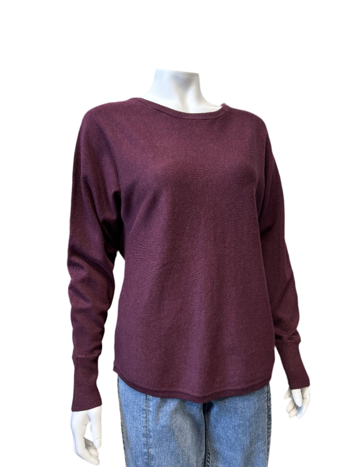 Mannequin wearing a maroon Sweater - SC-DOLLIE 620 by SoyaConcept and light blue jeans. The stylish sweater features a simple, relaxed fit with a round neckline. The plain white background emphasizes the clothing.