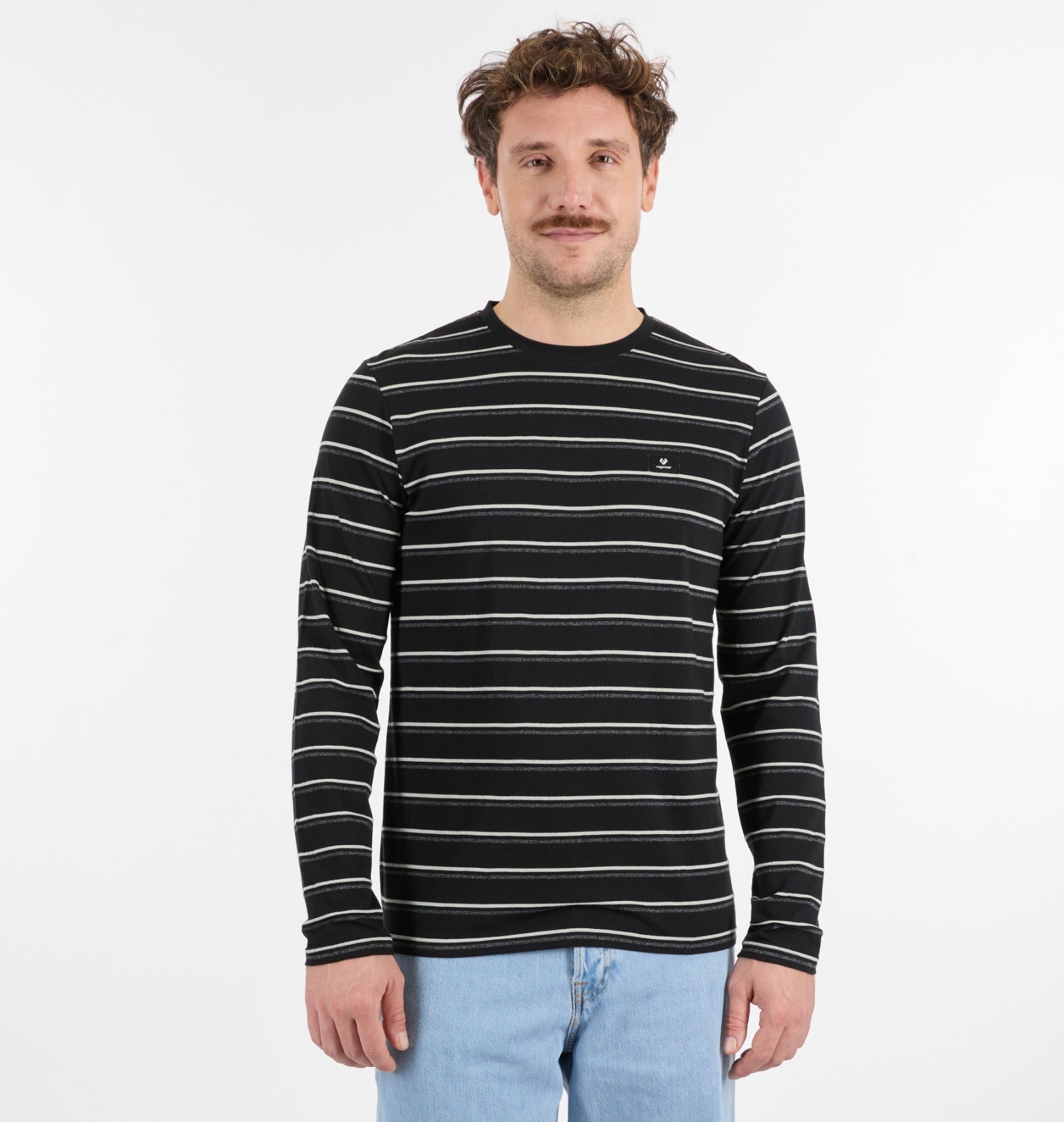 A man with short brown hair and a mustache stands against a plain white background, wearing the RAGWEAR ADDER STRIPE GOTS Long Sleeve men's shirt with thin white horizontal stripes and light blue jeans.