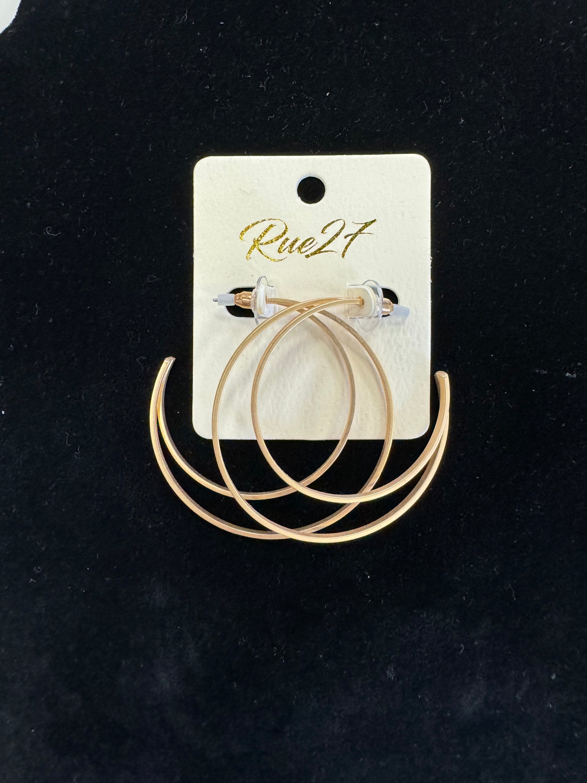 A pair of gold hoop earrings with an elegant beaded design is displayed on a white card featuring the brand name "Posies Flowers & Fashion Inc." written in gold script. These stylish Gold Moon Earrings stand out beautifully against a black background.