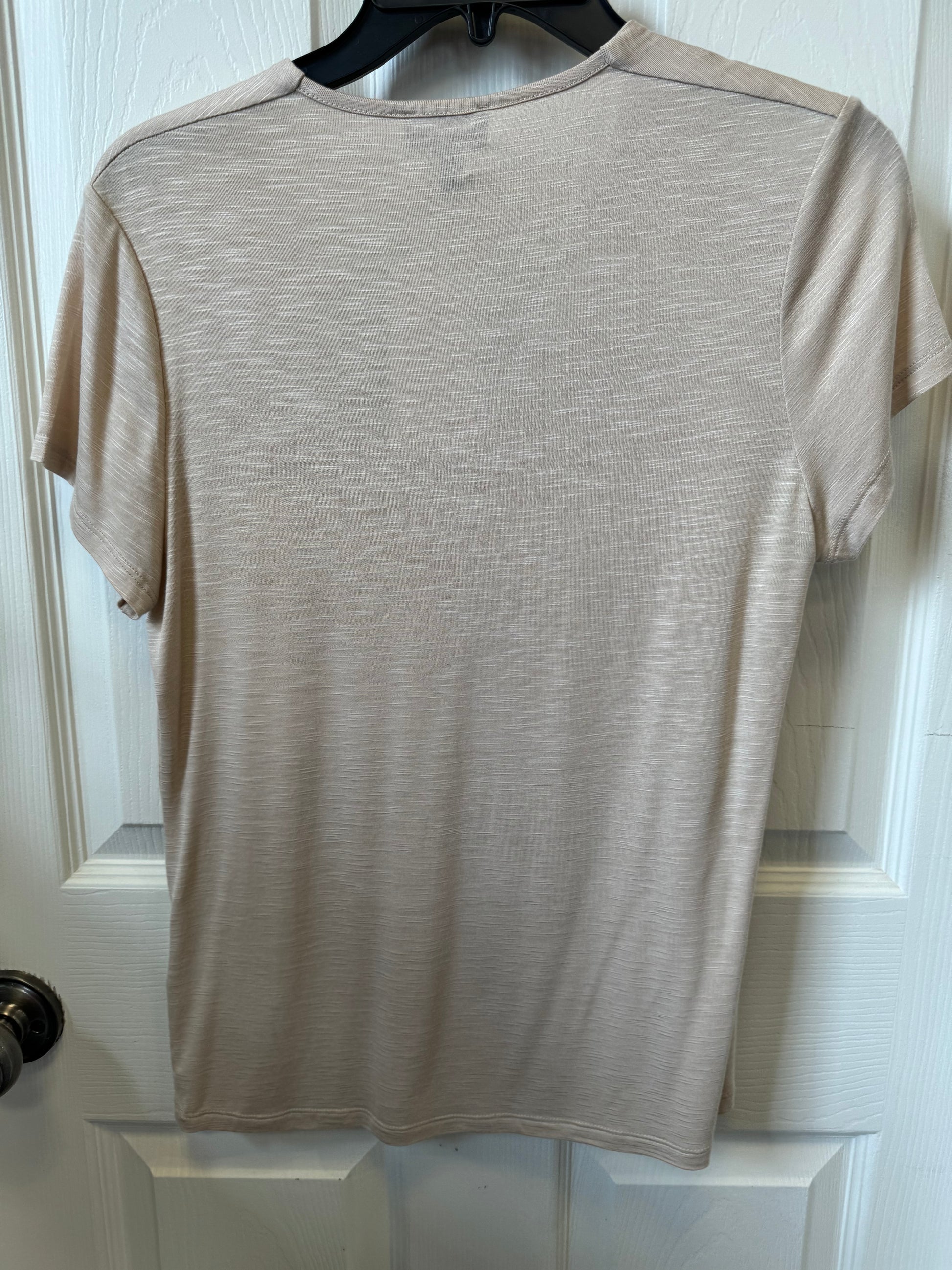 A Marble Fitted V-Neck T-Shirt - BEIGE 6539 is displayed on a black hanger against a white door. The shirt has a fitted silhouette, subtle marbled texture, and features a black rectangular tag with the brand name "MARBLE," along with a smaller label on the left bottom hem.