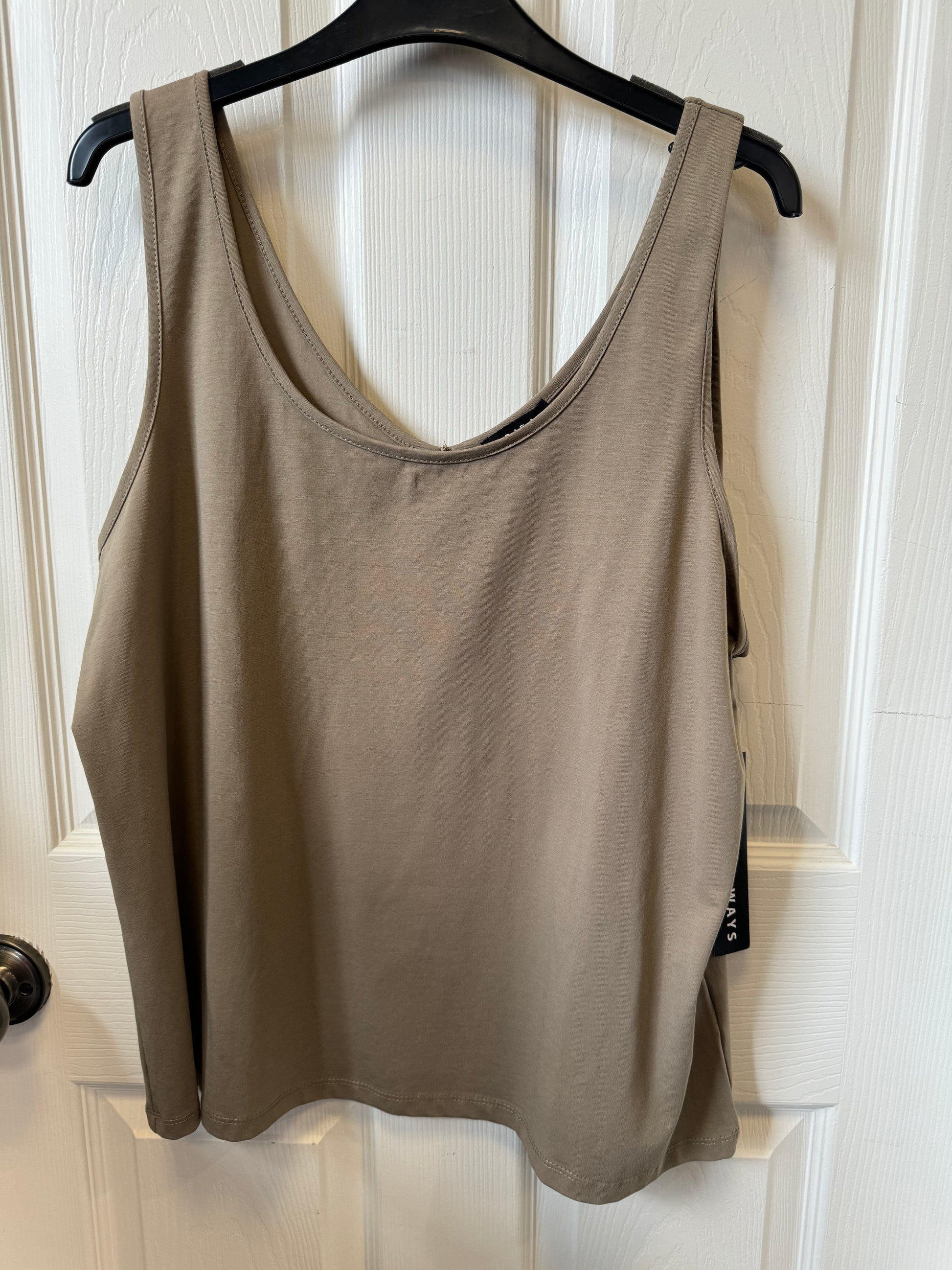 A chic, beige tank top—known as the Tribal Fern Tank Top (4820O-403-0407) from the brand Tribal—hangs elegantly on a black hanger against a white paneled door, perfect for any casual occasion.