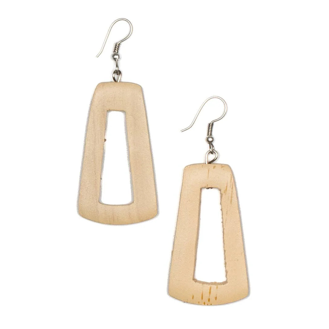 Introducing the Tinted Wood Rectangular Hoop Earrings in Cream by Suzie Blue. These artisanal earrings feature a cream-colored, rectangular shape with a central cutout and are made from wood, showcasing natural grain patterns. Each earring is fitted with a silver hook at the top for easy attachment to the ear, epitomizing Suzie Blue's dedication to craftsmanship.