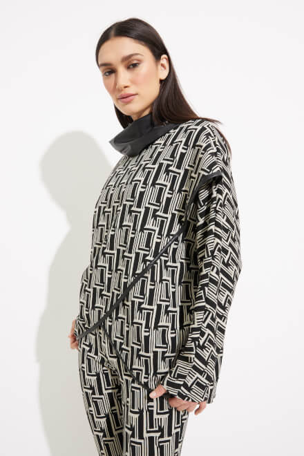 Against a white background, a woman showcases the SoyaConcept Abstract Print Shawl Collar Top Style 233227, paired with matching patterned pants featuring a striking geometric design. She complements her look with black high heels and long dark hair parted in the middle.