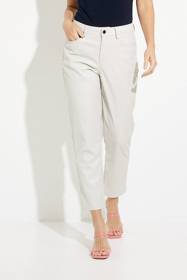 A person stands against a white backdrop, showcasing the sleek and durable Light Beige Pants from Joseph Ribkoff, paired with a dark top. Their ensemble is completed by bright pink, strappy sandals. Only their lower half is visible in the image.