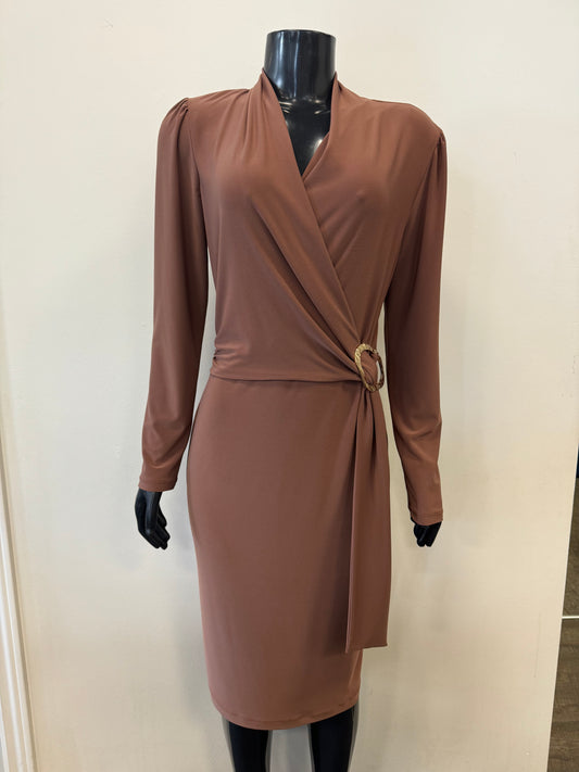 A mannequin displays the Wrap Front Belted Dress Style 233119 by Joseph Ribkoff, an elegant long-sleeved, knee-length brown fall dress featuring a deep V-neckline. The dress has a side buckle detail on the waist that creates a gathered effect. It is set against a plain, off-white background.