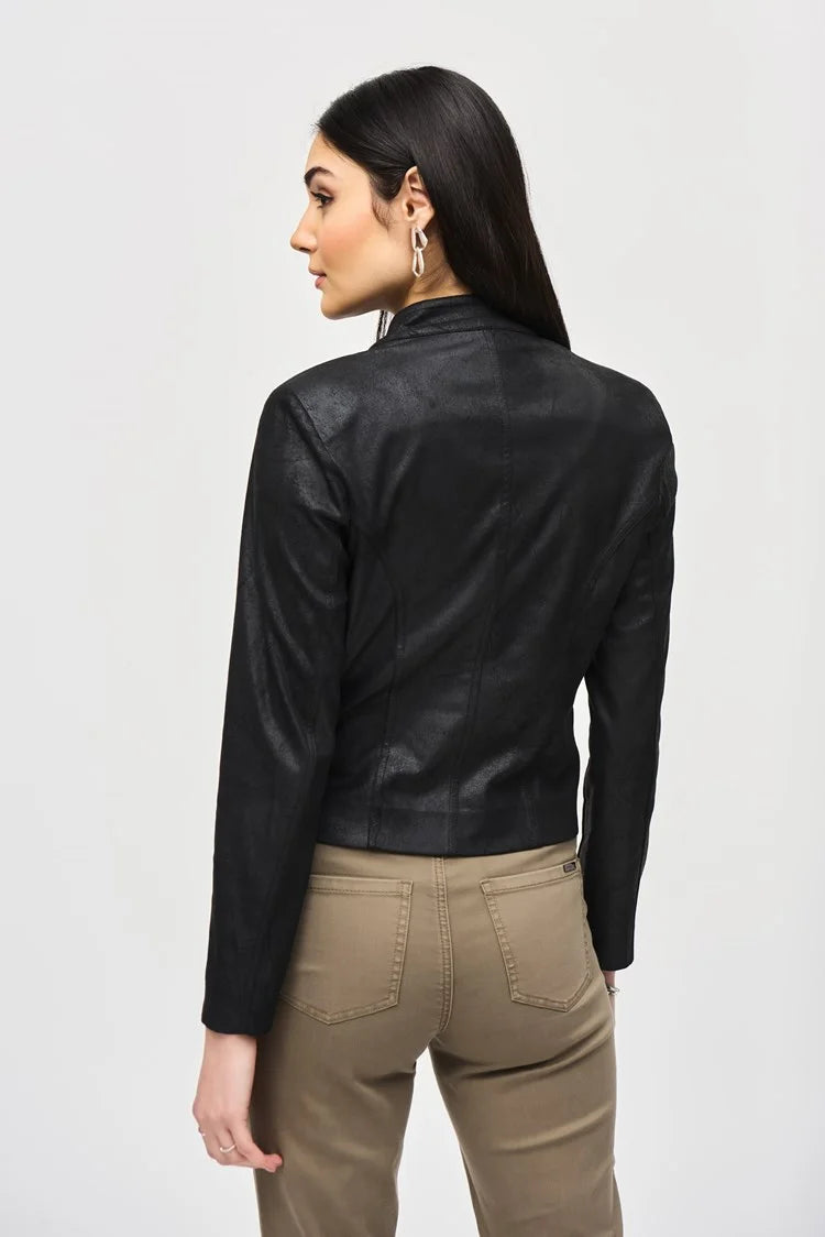 A woman stands against a plain white background, wearing the Joseph Ribkoff Faux Suede Jacket With Metallic Mesh Detail 243972. She pairs it with khaki straight-leg pants that are slightly cropped and black heeled ankle boots. Her long, dark hair cascades down, and she accessorizes with statement earrings.