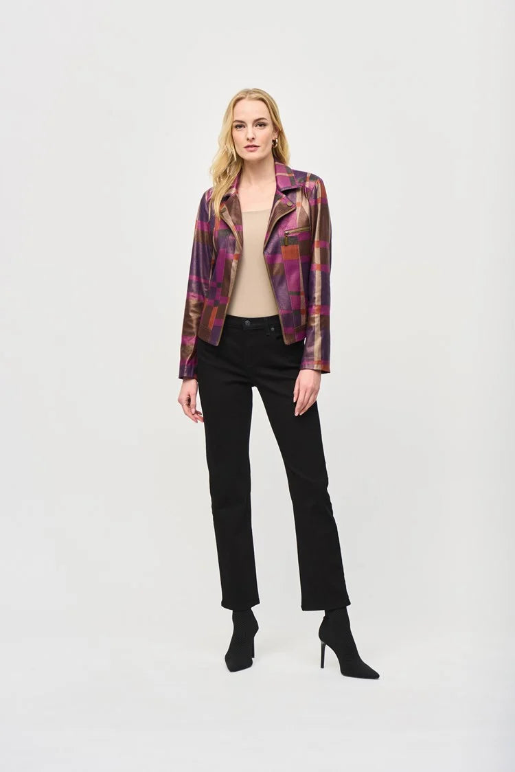 A person with shoulder-length blonde hair is leaning forward slightly while wearing the Foiled Print Faux Suede Jacket 243921 by Joseph Ribkoff over a light-colored top and taupe pants. The background is plain and light-colored, emphasizing the outfit and pose.