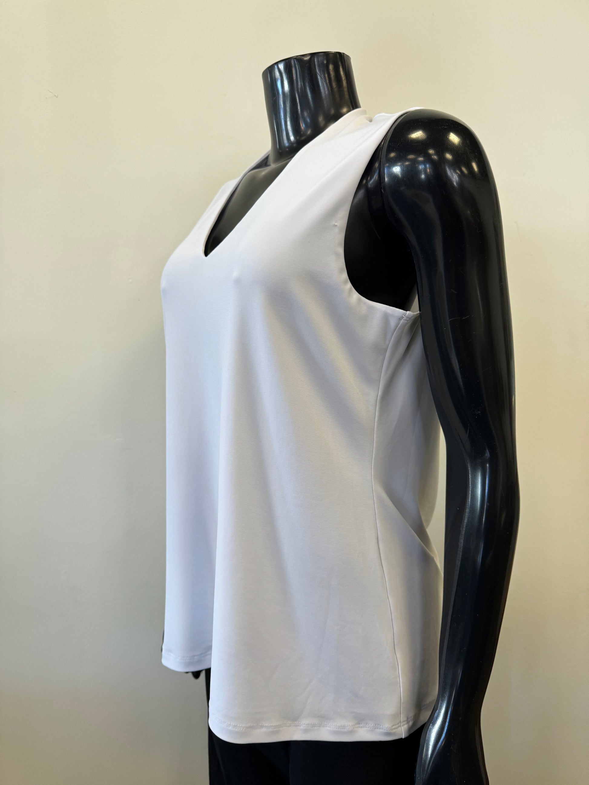 A black mannequin displays a sleeveless, deep V-neck, navy blue Bali Corp Bali Top Sleeveless 8326 paired with black trousers. The versatile top is made in Canada and stands out against the plain, white background.