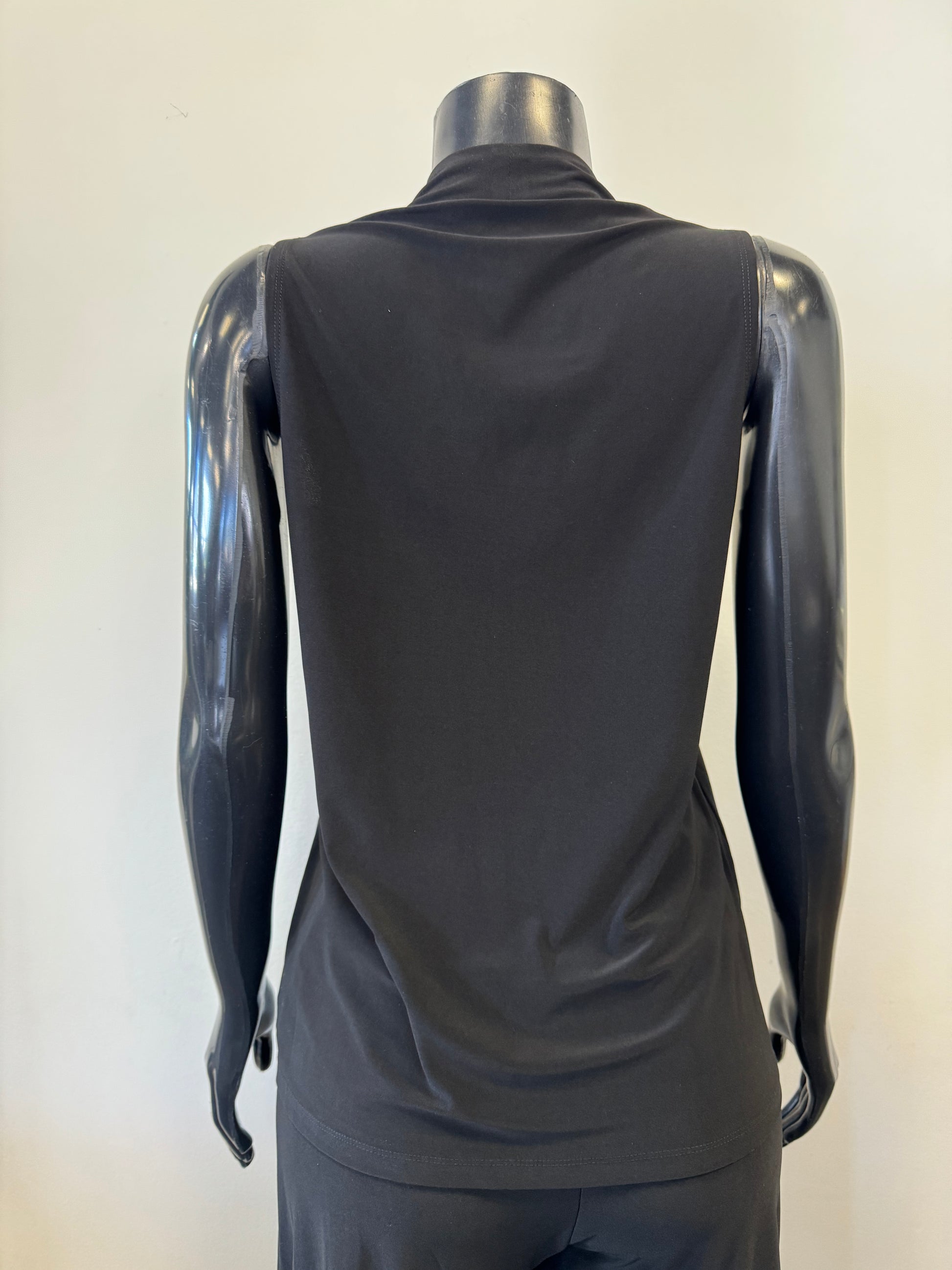 A black mannequin displays a sleeveless, deep V-neck, navy blue Bali Corp Bali Top Sleeveless 8326 paired with black trousers. The versatile top is made in Canada and stands out against the plain, white background.