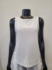 A black mannequin wears the Tank Top 6990-Bali Corp, a creamy white round neck design by Bali Corp, styled with a gold chain necklace against a plain light background.