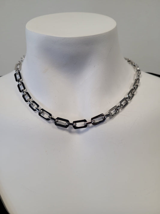 The Rhea 17 Necklace by Elise Accessories showcases a modern silver paper clip chain with rectangular links, displayed on a white mannequin bust—a versatile choice for any occasion.