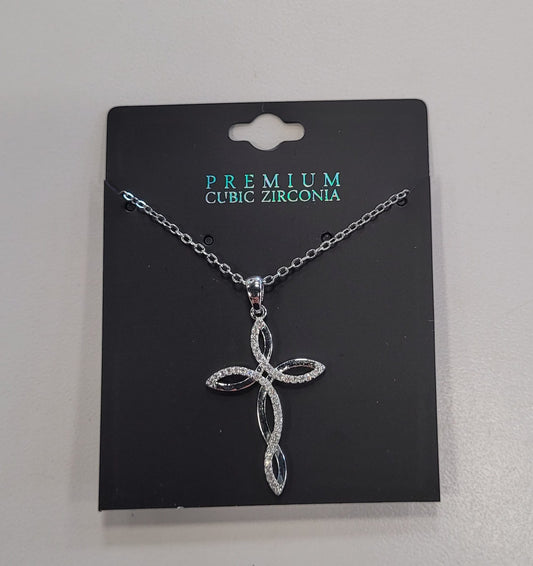The Trina 12 Necklace by Elise Accessories features a silver figure 8 cross with sparkling cubic zirconia on black "Premium Cubic Zirconia" packaging. Its elegant, intertwined design is perfect for layering with your favorite necklaces.