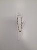 A beaded anklet with black and white beads on a foot-shaped display card, labeled “JULIET BY CRYSTAL AVENUE,” makes a perfect match for your favorite Angela 4 Anklet by Elise accessories.