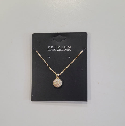 The Trina 8 Necklace by Elise accessories features a round pave pendant with cubic zirconia, displayed on a black card labeled "PREMIUM CUBIC ZIRCONIA," highlighting expert craftsmanship against a plain white background.