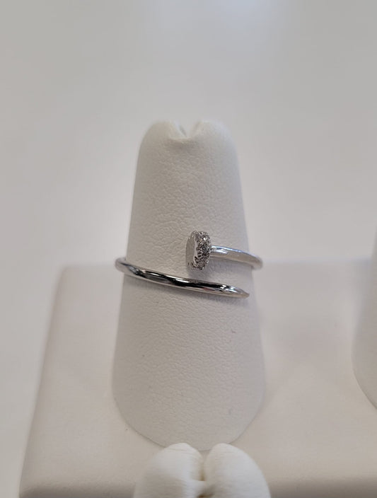 The Elisa 4 Ring by Elise Accessories is a minimalist sterling silver ring featuring an oval center detail, shown on a white ring holder with a soft, neutral background.