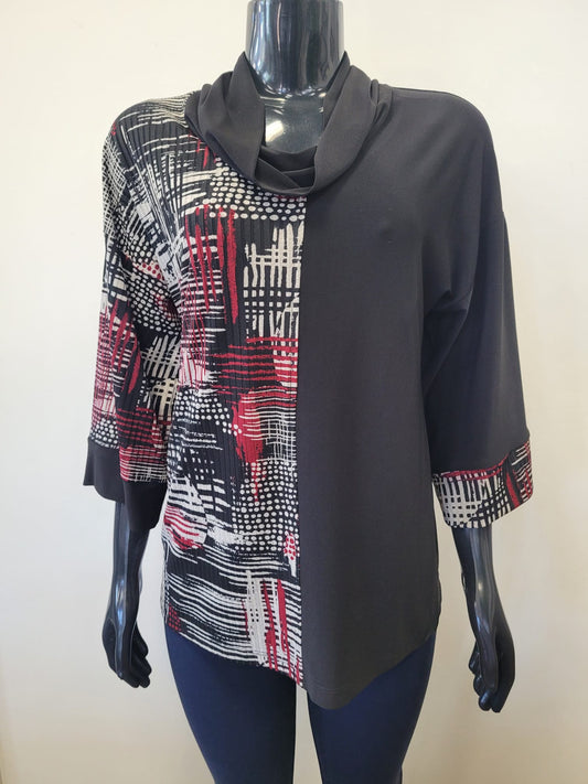 A mannequin showcases Bali Corp's Intricate Top -8749, a chic long-sleeve with a black cowl neck, red-white-gray abstract print on the left, solid black on the right, and matching cuffs for a versatile look.