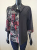 A mannequin showcases Bali Corp's Intricate Top -8749, a chic long-sleeve with a black cowl neck, red-white-gray abstract print on the left, solid black on the right, and matching cuffs for a versatile look.