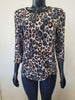 A mannequin models the Bali Corp Large Leopard Print Top -8735, featuring long sleeves, ruched sides with drawstrings, paired with dark pants against a plain background.