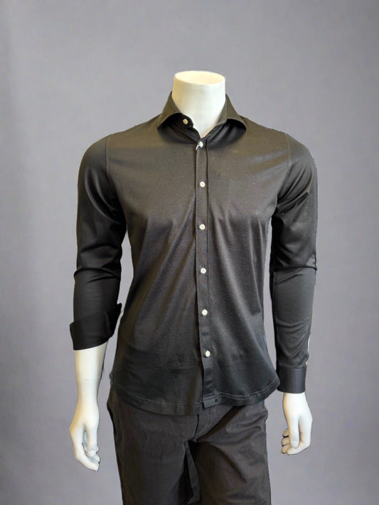 Introducing the Paul Miranda Cotton Shirt Black displayed on a white mannequin torso. This black, long-sleeve button-up shirt from Paul Miranda has a slight sheen and is fully buttoned, paired perfectly with matching black pants. The ensemble is set against a plain, gray background, exuding classic elegance.