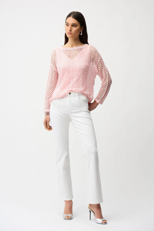 A woman with long brown hair and a neutral expression wears the Joseph Ribkoff Sequins Yarn Chevron Print Long Sleeve Sweater 261915 over a light top, white high-waisted pants, and silver heels against a plain white background.