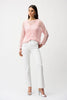 A woman with long brown hair and a neutral expression wears the Joseph Ribkoff Sequins Yarn Chevron Print Long Sleeve Sweater 261915 over a light top, white high-waisted pants, and silver heels against a plain white background.