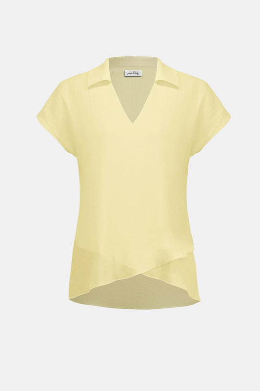 The Joseph Ribkoff Bubble Chiffon High-Low Layered Top (262148) features a light yellow crinkled fabric, V-neck shirt collar, short sleeves, and an asymmetric flared hem. Displayed on a plain white background.