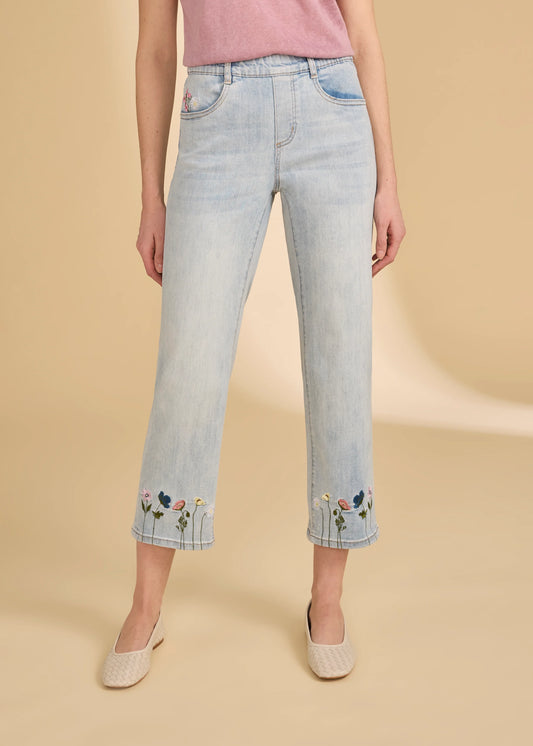 A person wears the French Dressing Jeans Pull-On Straight Crop Denim in Light Wash, styled with a pink top and light-colored flats, standing against a beige background.