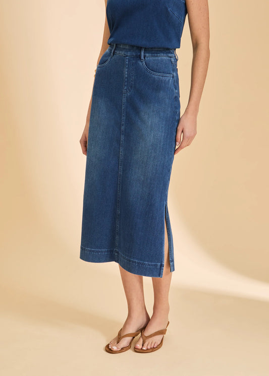 A person wears a blue sleeveless top, French Dressing Jeans Pull-On Skirt with Slits in Blue Denim (6983131-BLUDEM), and brown sandals, standing against a beige background.
