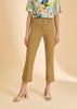 A woman wears Suzanne Boot Crop Pants in Henna by French Dressing Jeans, a colorful floral blouse, and beige heeled sandals against a beige background. Her face is not visible.