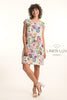 A woman smiles in a short-sleeved, knee-length French Linen Dress TP1764P-85 Pink by LinenLuv, featuring colorful floral prints. "LinenLuv" appears to the right against a light background.