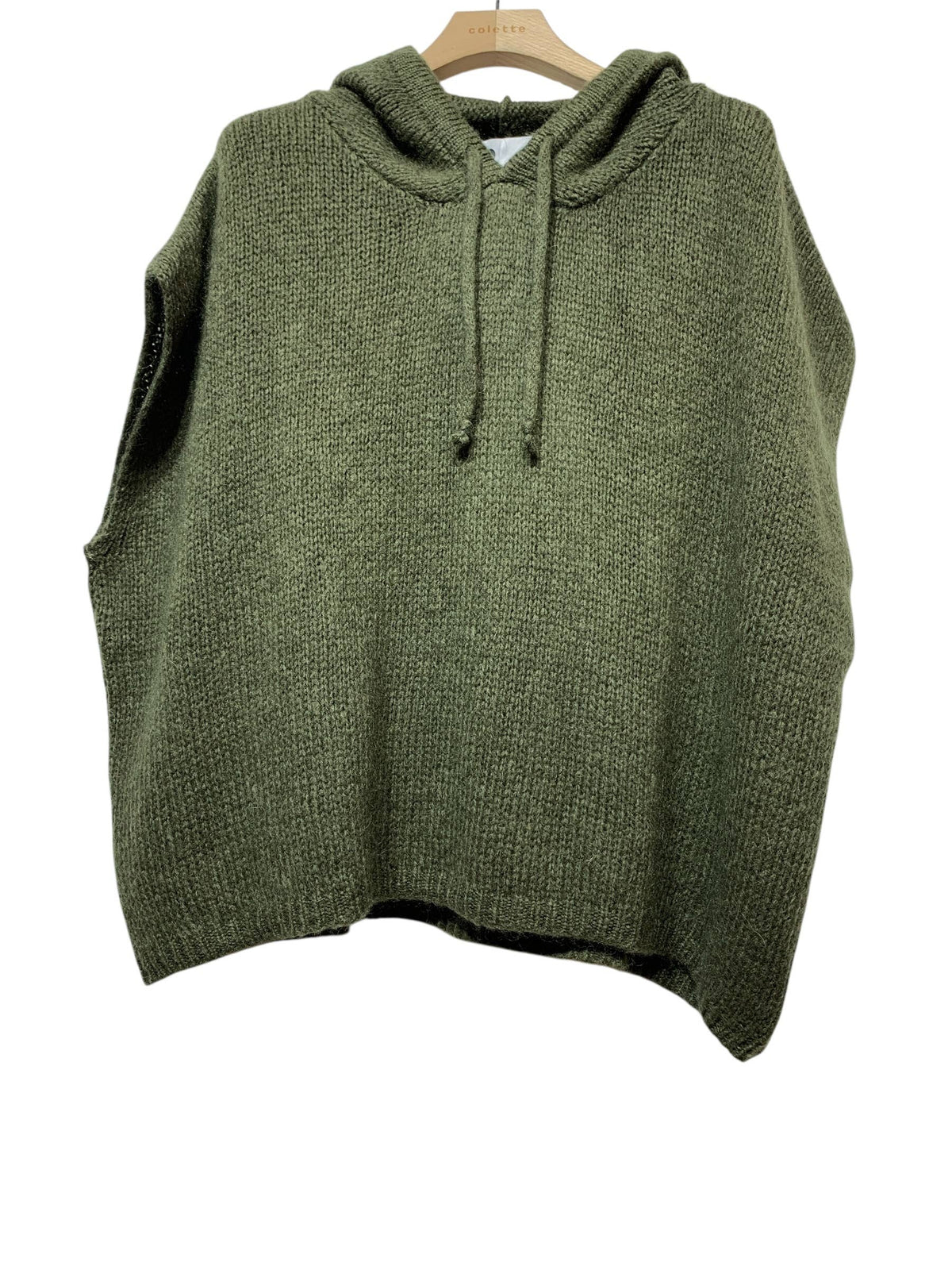 The 1622A PONCHO FALL WINTER: KAKI by LINEN & COTTON HOUSE is an olive green knitted sleeveless hoodie, inspired by the elegance of an Italian poncho, displayed on a wooden hanger against a white background—perfect as a cozy wrap for fall and winter.