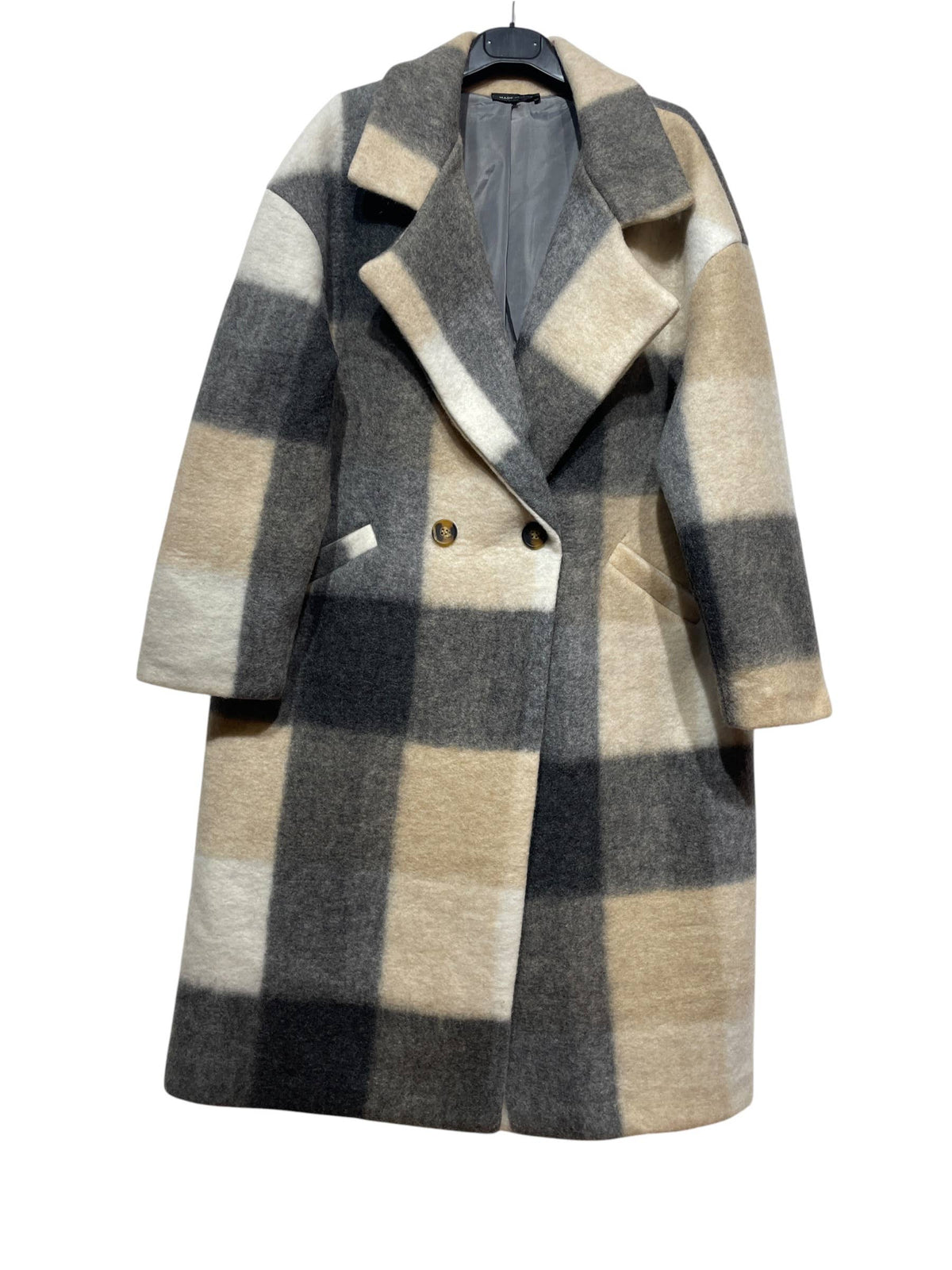 Showcased on a hanger against a white background, the 50706 FALL WINTER CLOTHING COATS: Beige from LINEN & COTTON HOUSE features large black, gray, beige, and white checks in a wool blend fabric. This stylish outerwear is designed with a wide collar, two buttons, and convenient side pockets—perfect for elevating your fall and winter wardrobe.